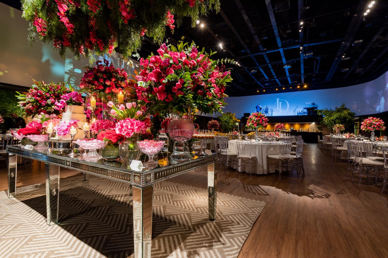 Lavish wedding reception with vibrant floral arrangements and elegant table setup.