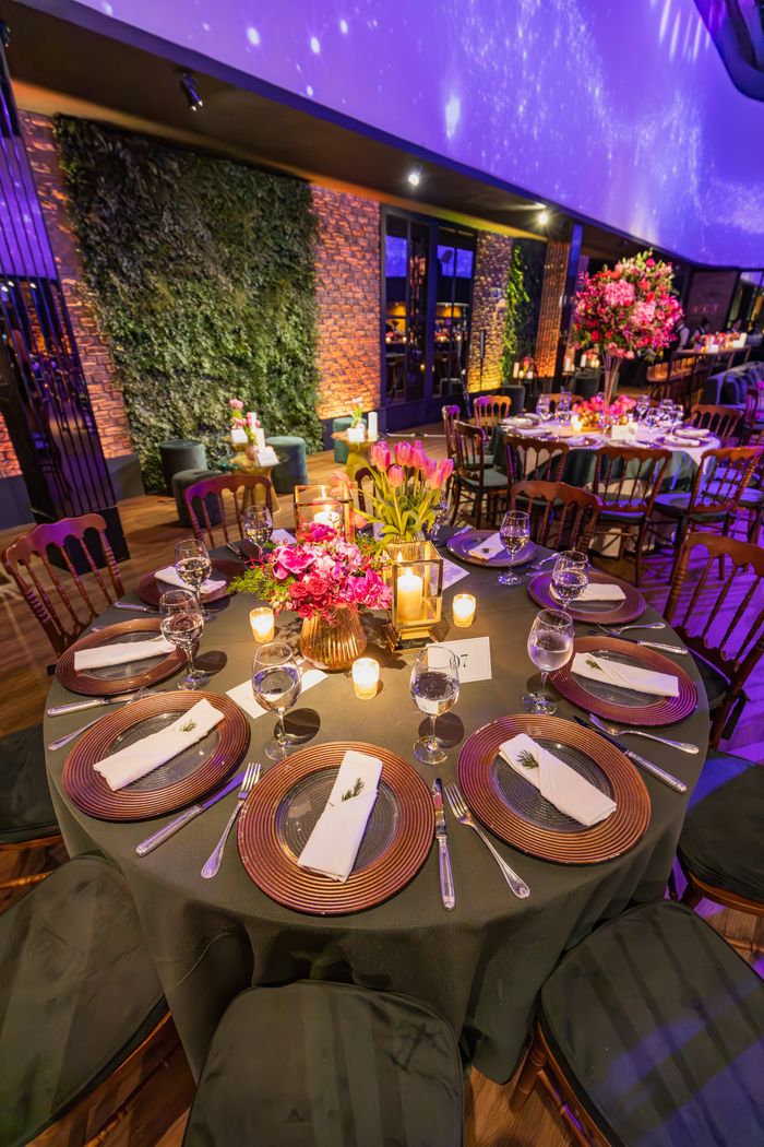 our-story Luxurious dining table with floral decor in a vibrant restaurant setting.