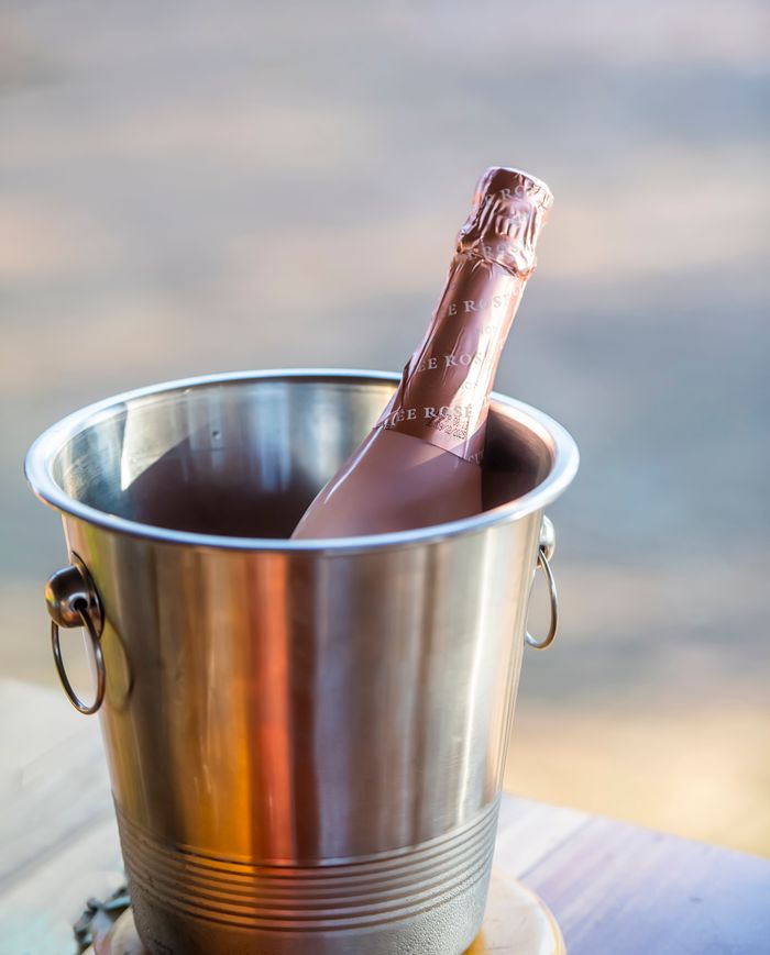 services-02 A chilled bottle of champagne in a metallic ice bucket perfect for special occasions.
